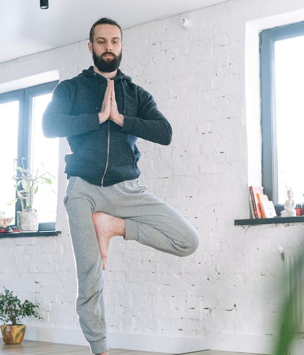 A focused man balancing during a workout, symbolizing mental and physical stability.